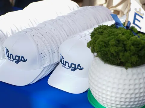 White Kings caps arranged on a blue table.