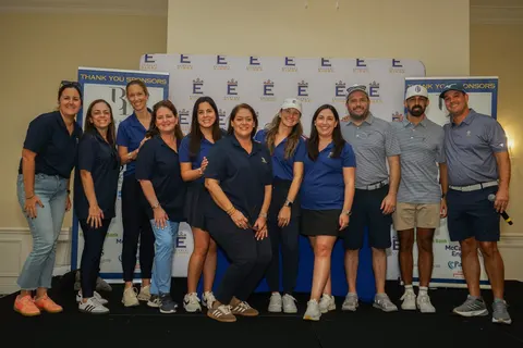 A large group poses together at the tournament reception.